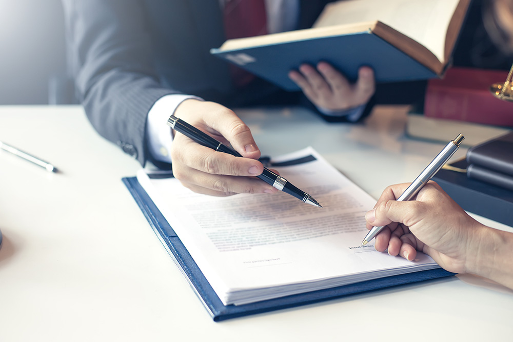 Collection lawyer and client signing a contract